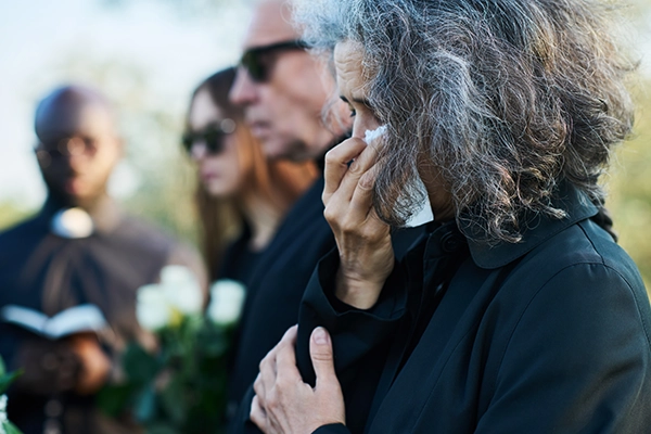 family grieving at a funeral