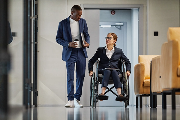 Woman in a wheelchair talking with a coworker